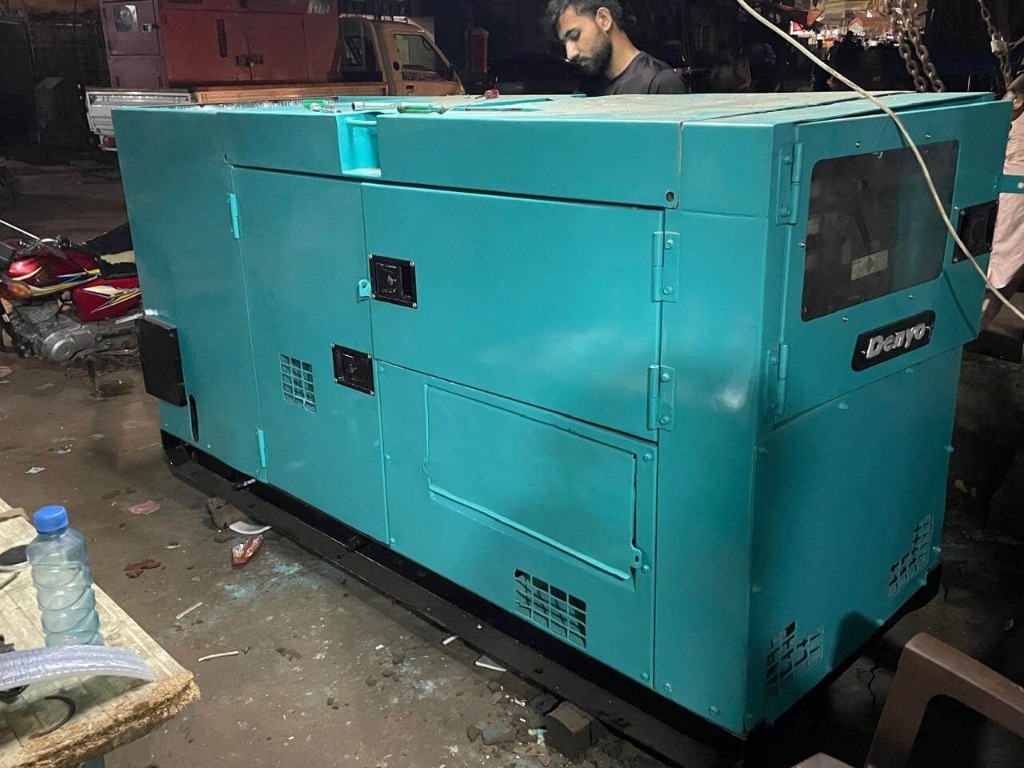 Teal Denyo generator in dark workshop